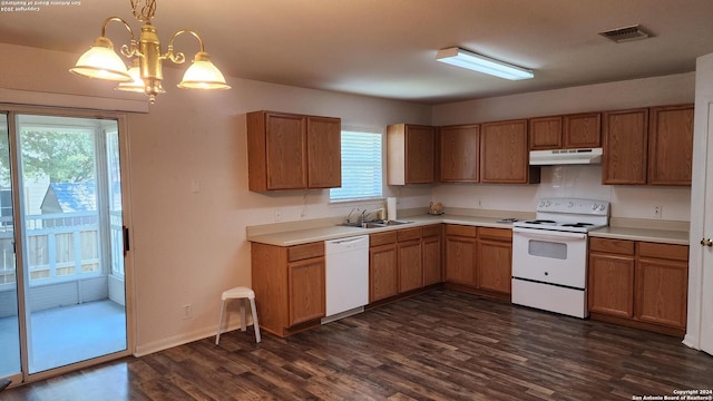 kitchen featuring dark wood-style floors, white appliances, visible vents, and under cabinet range hood