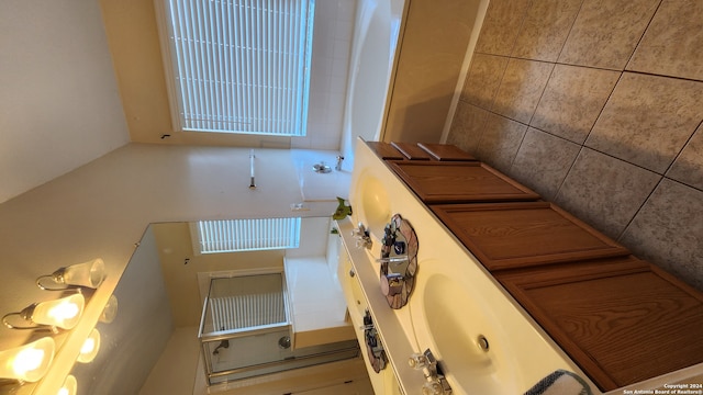 bathroom with tile walls