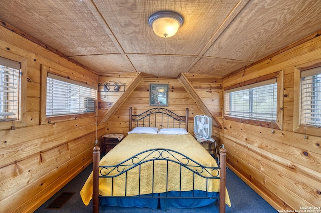 bedroom featuring wood ceiling, wooden walls, and multiple windows