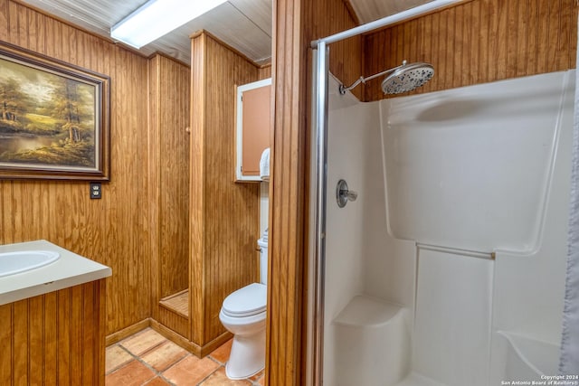 bathroom with toilet, vanity, tile patterned floors, and walk in shower