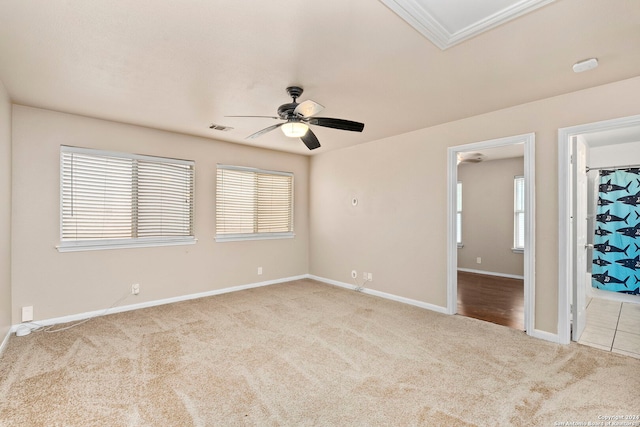 carpeted spare room with ceiling fan