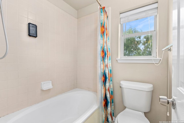 bathroom with toilet and shower / bath combo with shower curtain