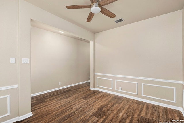 spare room with ceiling fan and dark wood-type flooring