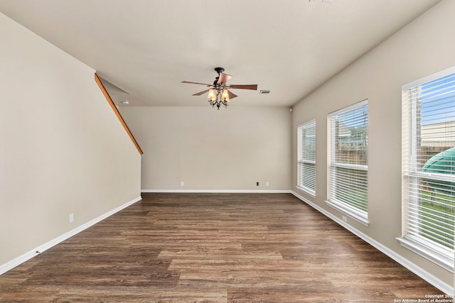 unfurnished room with ceiling fan and dark wood-type flooring