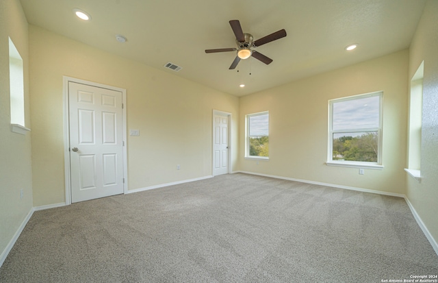 carpeted empty room with ceiling fan