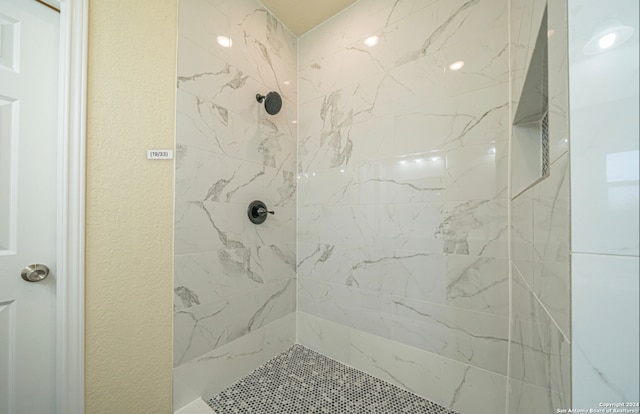 bathroom with tiled shower