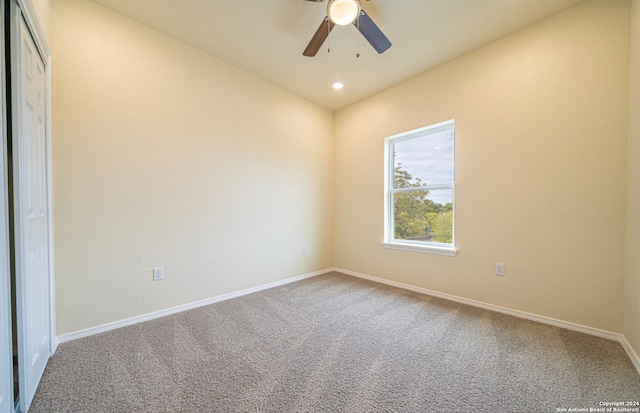 empty room featuring ceiling fan and carpet flooring