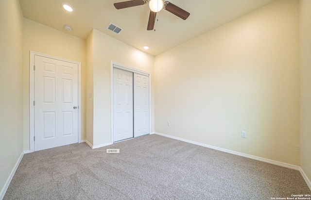 unfurnished bedroom with ceiling fan, carpet floors, and a closet