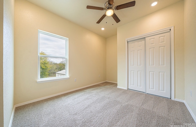 unfurnished bedroom featuring a closet, ceiling fan, and carpet