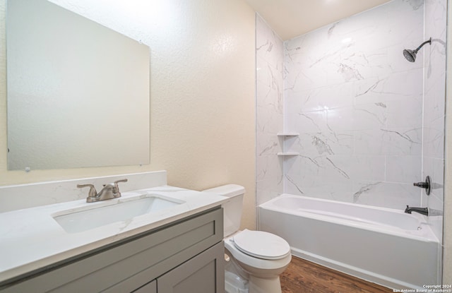 full bathroom with hardwood / wood-style flooring, vanity, toilet, and tiled shower / bath combo