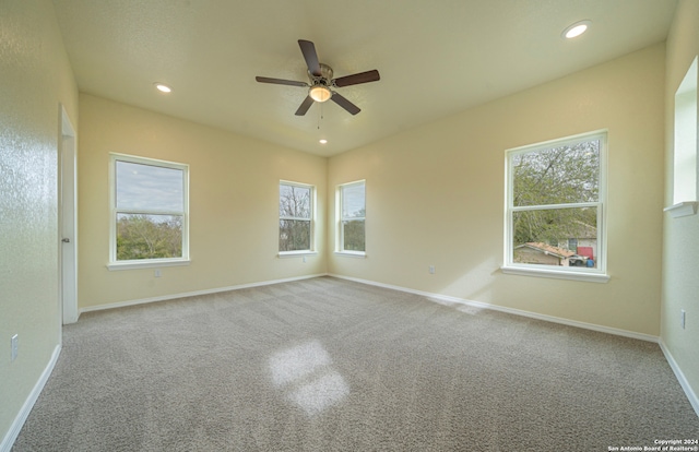 carpeted empty room featuring ceiling fan