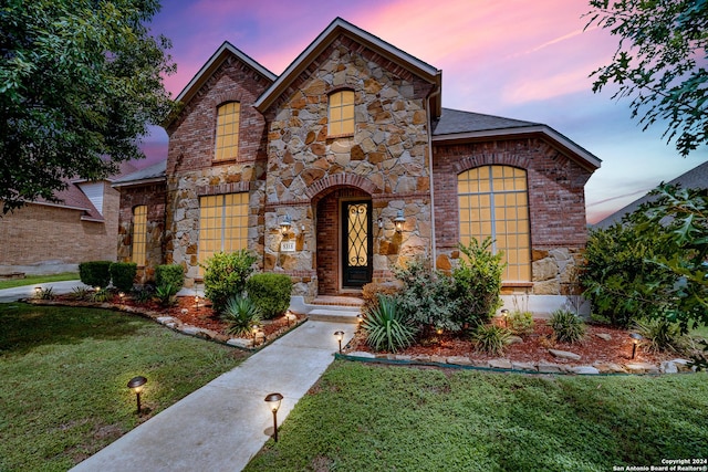 view of front of home with a lawn