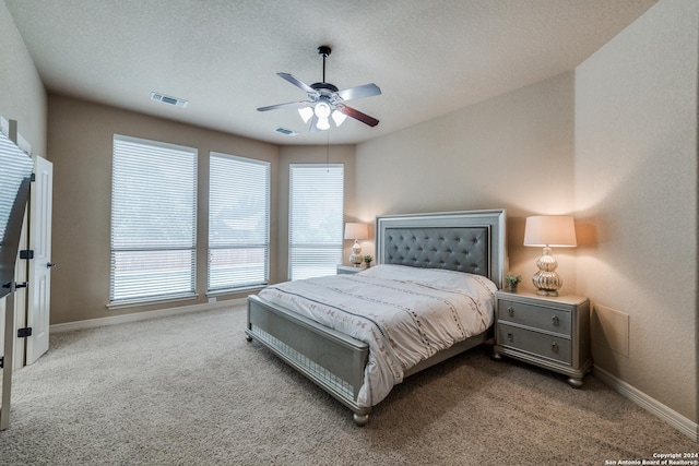 bedroom with ceiling fan, carpet flooring, and multiple windows