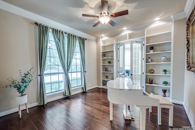 misc room with ceiling fan, a healthy amount of sunlight, dark hardwood / wood-style flooring, and ornamental molding