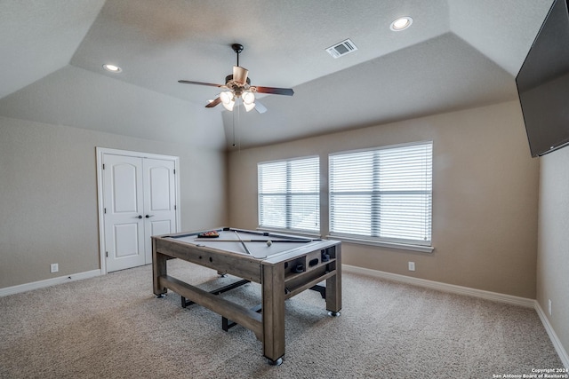 rec room featuring a raised ceiling, lofted ceiling, light colored carpet, and ceiling fan