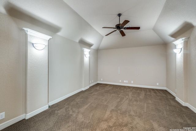 interior space featuring lofted ceiling, ceiling fan, and carpet flooring