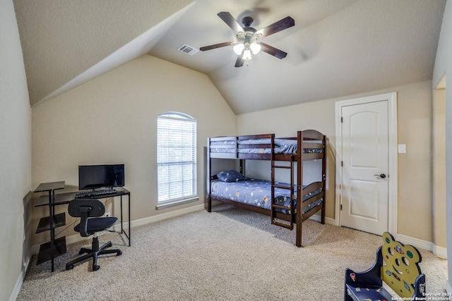 bedroom featuring ceiling fan, vaulted ceiling, and light carpet