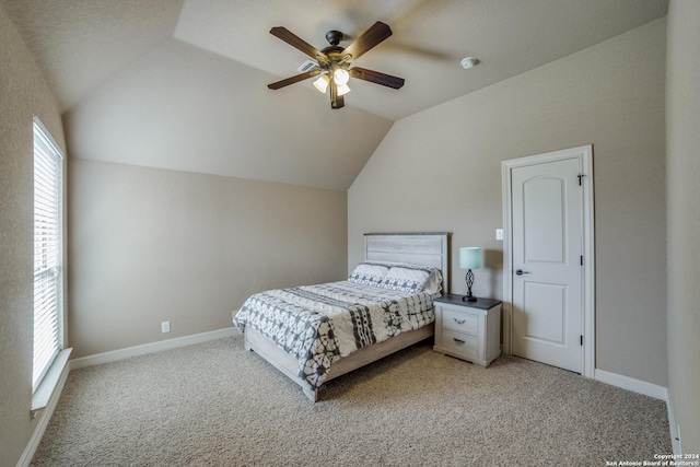 carpeted bedroom with vaulted ceiling and ceiling fan