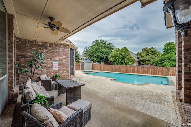 view of pool with ceiling fan, a storage shed, an outdoor hangout area, and a patio area