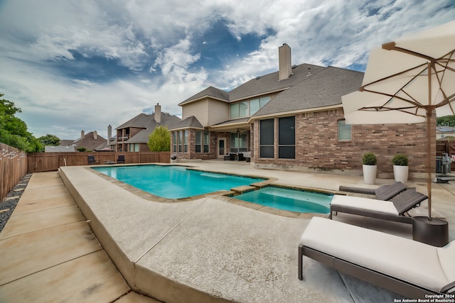 view of pool featuring a patio area and an in ground hot tub