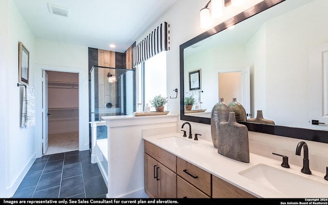 bathroom featuring independent shower and bath, tile patterned floors, and dual bowl vanity