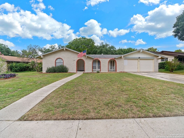 single story home with a garage and a front lawn