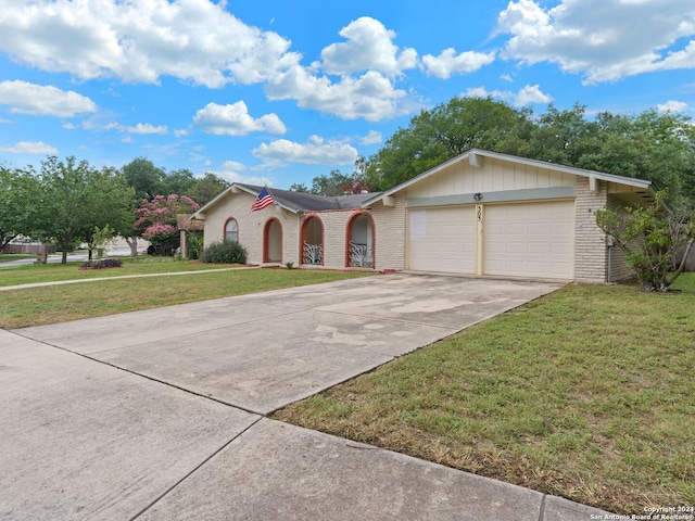 ranch-style home with a garage and a front yard