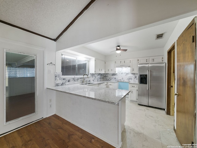 kitchen featuring light hardwood / wood-style floors, white cabinetry, stainless steel refrigerator with ice dispenser, and kitchen peninsula