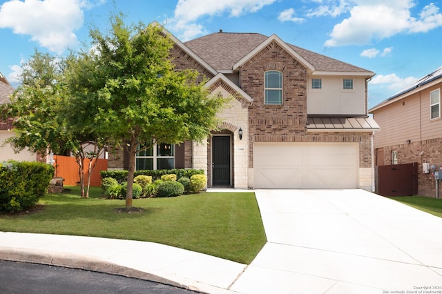 view of front of property with a garage and a front lawn