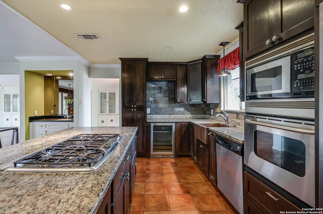 kitchen with crown molding, wine cooler, backsplash, stainless steel appliances, and tile patterned floors