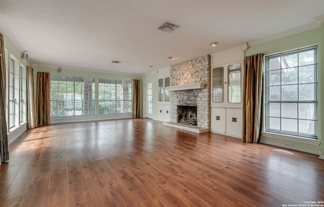 unfurnished living room with a fireplace, hardwood / wood-style floors, and ornamental molding