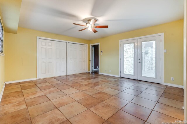 unfurnished bedroom with light tile patterned floors, french doors, access to exterior, and ceiling fan