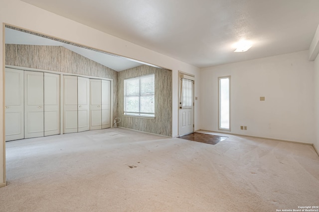 interior space with a wealth of natural light and lofted ceiling