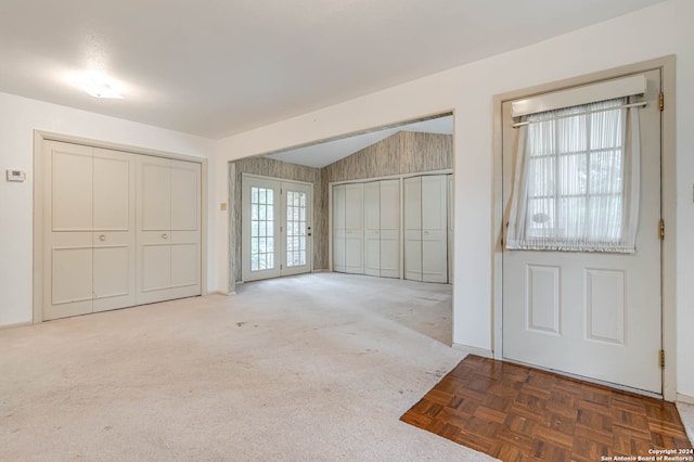 entryway featuring parquet floors and lofted ceiling