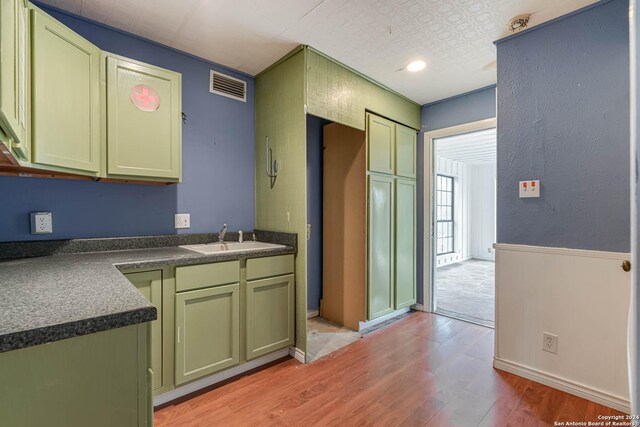 kitchen with light hardwood / wood-style flooring and sink