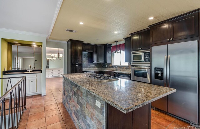 kitchen with light tile patterned floors, tasteful backsplash, a kitchen island, and stainless steel appliances