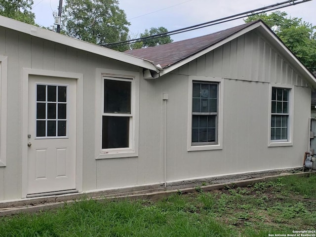 view of property exterior with a shingled roof