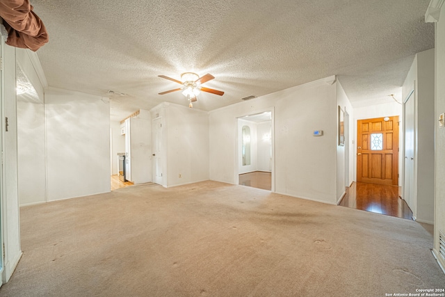 unfurnished room featuring a textured ceiling, ceiling fan, and light hardwood / wood-style floors