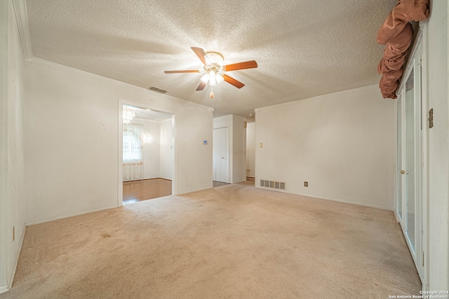 carpeted spare room with a textured ceiling, ceiling fan, and ornamental molding