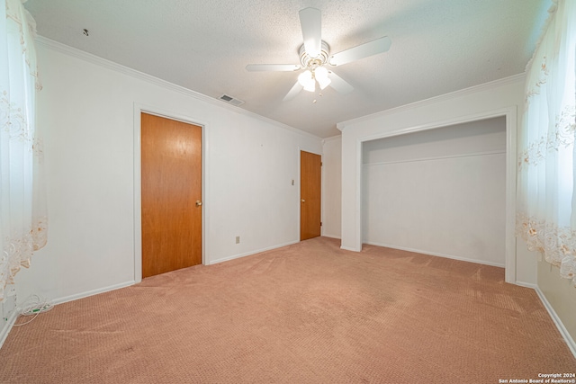 unfurnished bedroom featuring carpet, ornamental molding, and ceiling fan