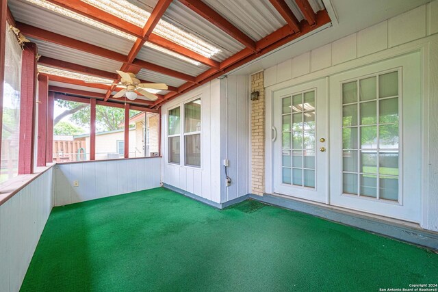 unfurnished sunroom featuring beam ceiling, french doors, coffered ceiling, and ceiling fan