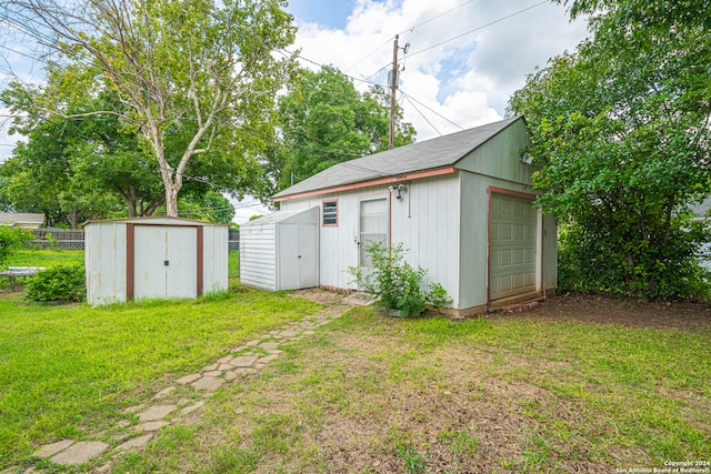 view of outbuilding with a garage and a yard