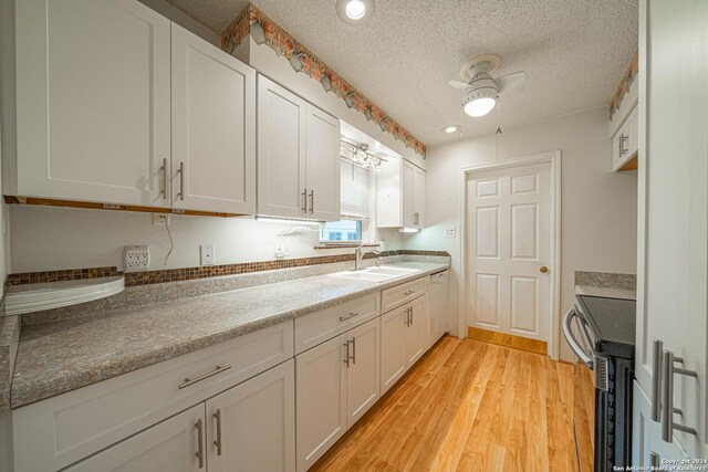 kitchen with white cabinetry, ceiling fan, light hardwood / wood-style floors, and range with electric stovetop