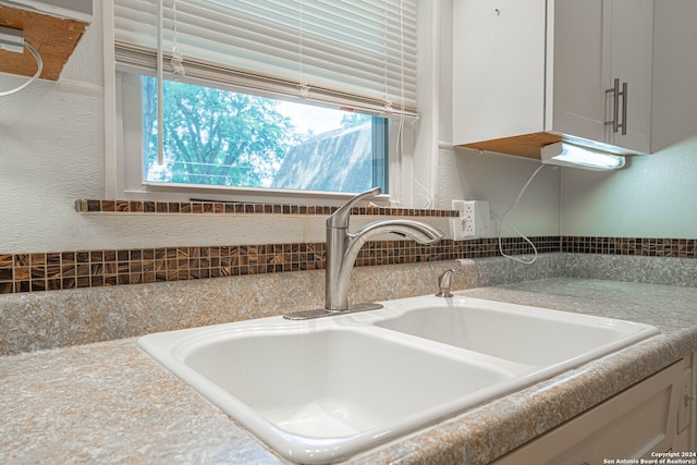 details with white cabinets and sink