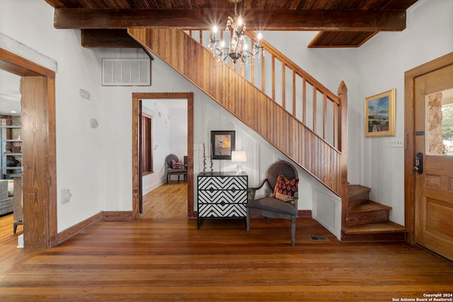 foyer with wood ceiling, beamed ceiling, a chandelier, and light hardwood / wood-style flooring