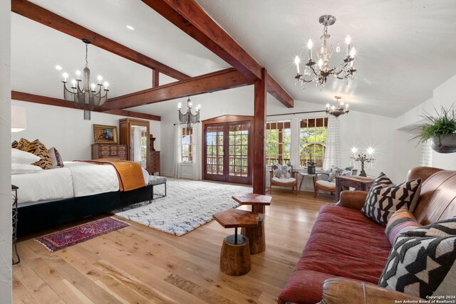 living room featuring high vaulted ceiling, an AC wall unit, french doors, and an inviting chandelier