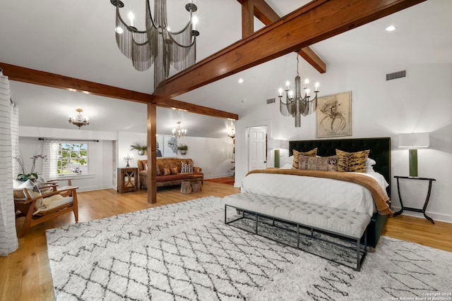 bedroom with an inviting chandelier, light hardwood / wood-style floors, and vaulted ceiling with beams