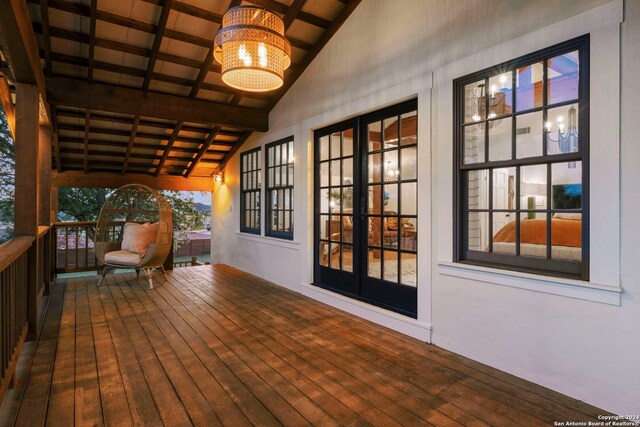 living area featuring hardwood / wood-style flooring and a notable chandelier