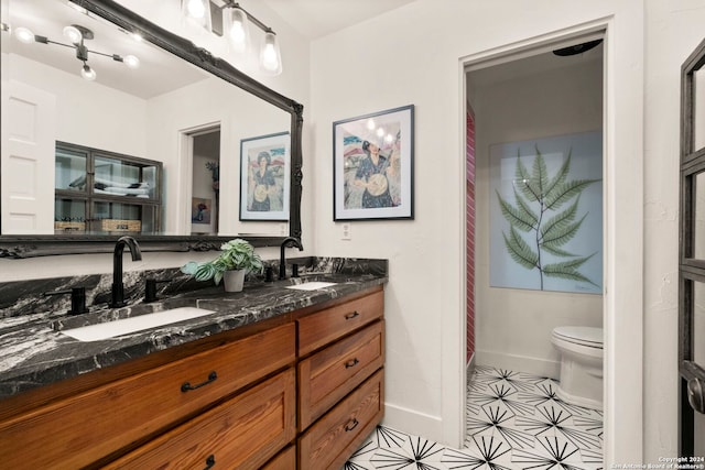 bathroom featuring toilet and vanity