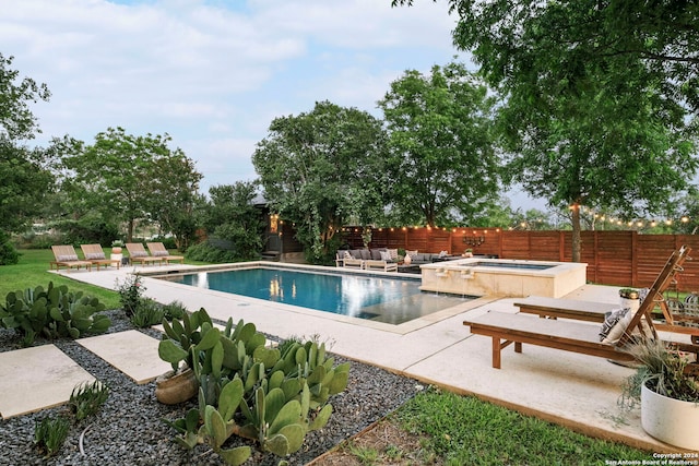 view of swimming pool with a patio and an in ground hot tub